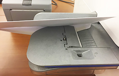 Envelope flap fed underneath the feed deck